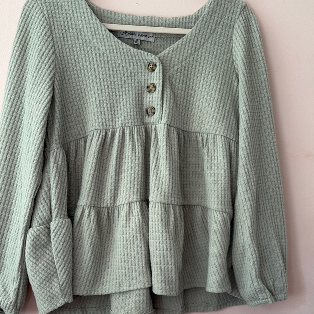 Green V-neck puff sleeve blouse with tiered design and 3/4 sleeves